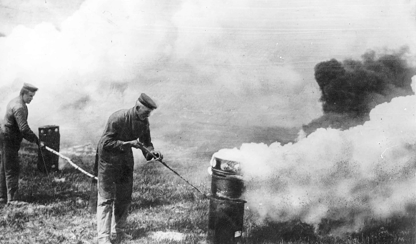 A soldier releasing chlorine gas from a tank during WW I.